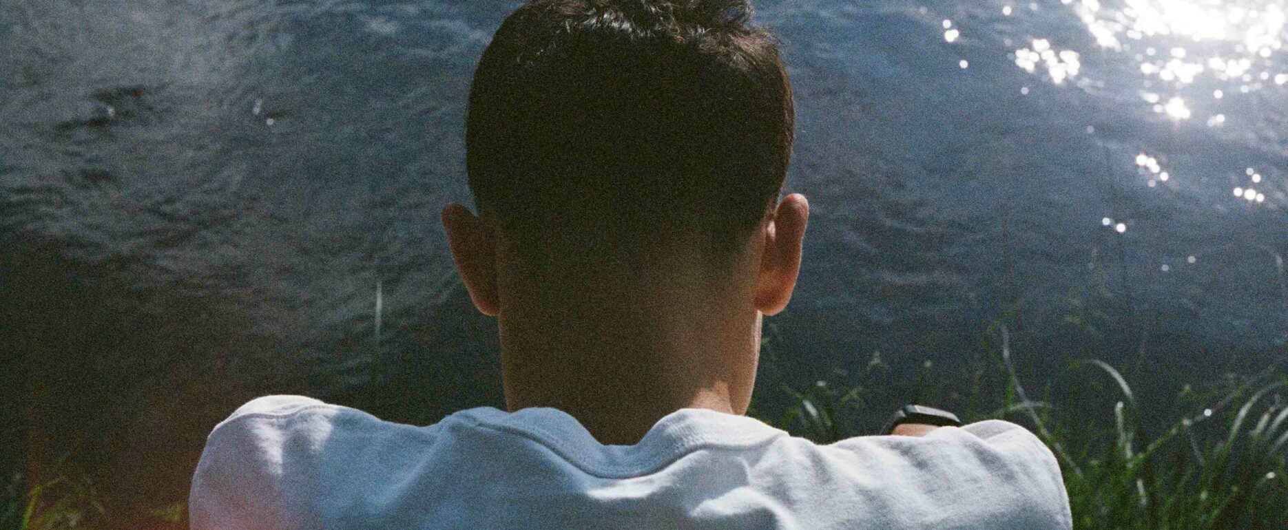 Aidan Aibeche memoir author contemplating emotions and thoughts in water
